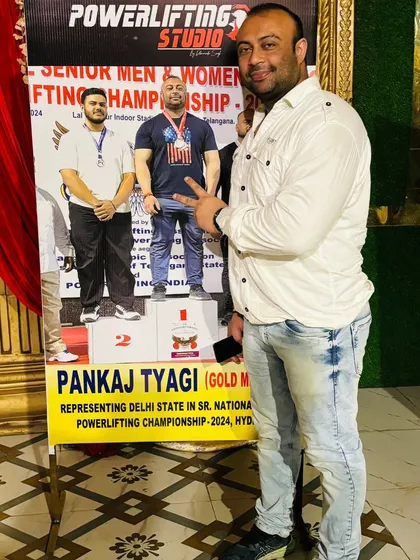 Standing next to a poster of myself. I haven't accepted defeat yet.
