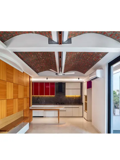 Functional spaces like kitchens can also be works of art. Here, exposed load-bearing brick vaults form the ceiling, contrasting with modern cabinetry and a custom breakfast table, proving that structural honesty and daily life can coexist beautifully.