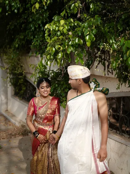 A sweet, interactive shot of the couple. Her makeup looks natural and radiant, allowing her happy expressions to be the main focus.