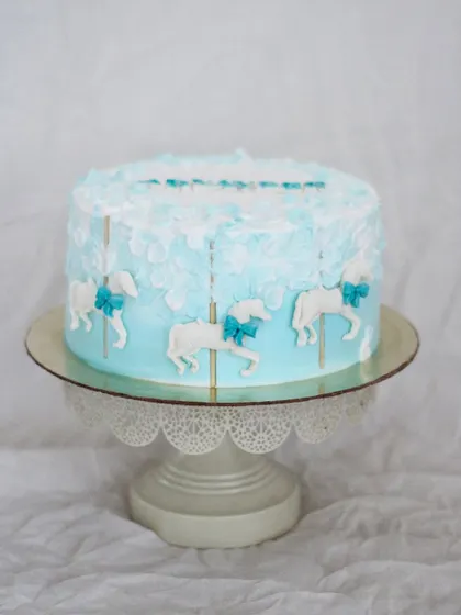 A sweet carousel cake for a little one’s naming ceremony. The soft blue and white color scheme with delicate carousel horses is perfect for celebrating a new baby boy.