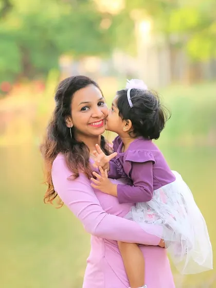 A daughter's sweet kiss for her mom. Outdoor photoshoots are perfect for capturing these spontaneous, love-filled moments in a beautiful, natural setting.