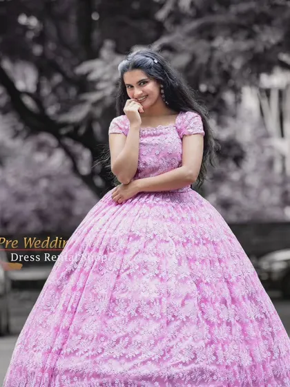 A close-up portrait in the pink lace ball gown, with artistic color grading to create a dreamy mood.