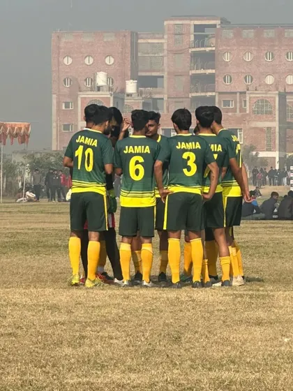 Another angle of the team huddle, showing the focus and unity of our football players. This bond is forged in training and is our biggest strength on the field.