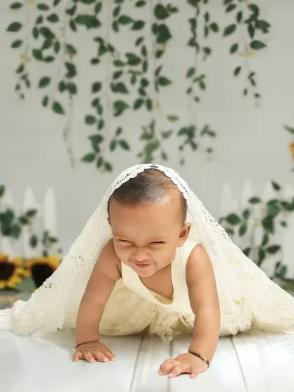 A playful game of peek-a-boo under a lace blanket. I encourage these simple, fun interactions to bring out the most genuine expressions and scrunched-nose smiles.