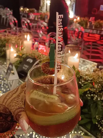 The little details matter. We offer personalized drink stirrers with your wedding hashtag, like this 'EastSaysYesToWest' stirrer, making every cocktail a part of your story.