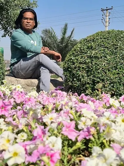 Sitting amongst the flowers. This photo captures the feeling of peace and satisfaction that a well-designed garden can bring.