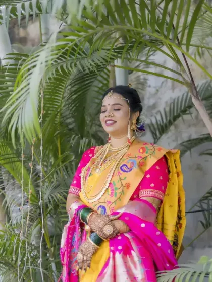 A serene bridal portrait amidst lush greenery, her eyes closed in a moment of peaceful happiness.