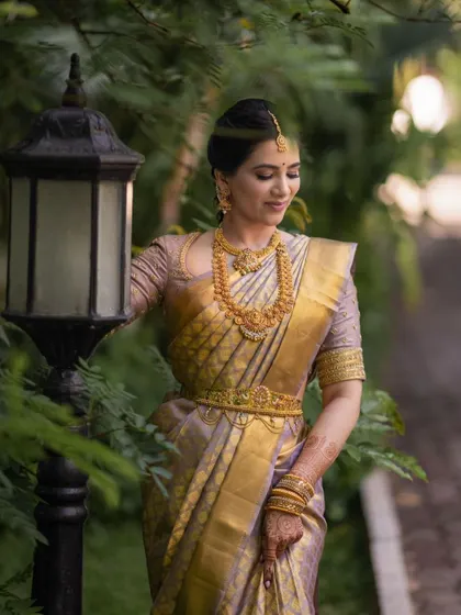 A full-length outdoor portrait showcasing the elegance of the silk saree and the classic updo.