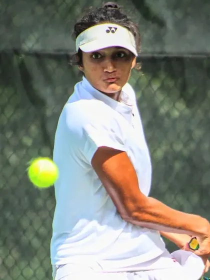 A focused moment for Sahaja as she tracks the ball, showcasing the concentration needed at the professional level.