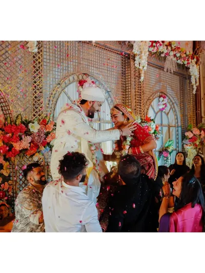 The varmala ceremony, with the groom being lifted up by his friends in a playful tradition.