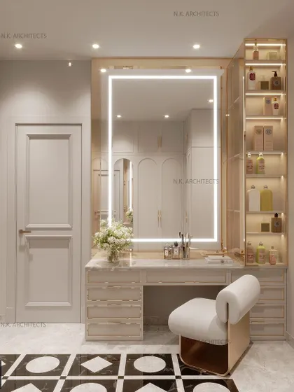The vanity area in this walk-in closet is designed for a star. It features a large mirror with integrated LED lighting, ample storage, and a comfortable, stylish chair.