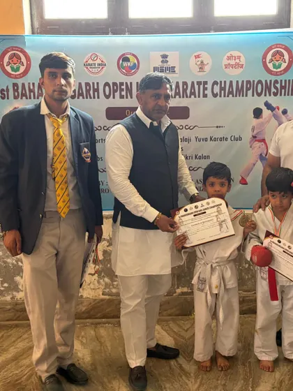 Two young brothers, both students, with their hard-earned certificates.