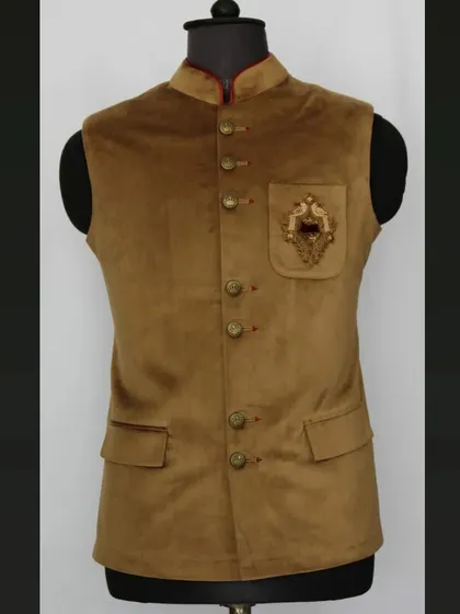 A designer Nehru jacket in brown velvet with a custom embroidered pocket crest. I can add unique details like this to make your outfit one-of-a-kind.