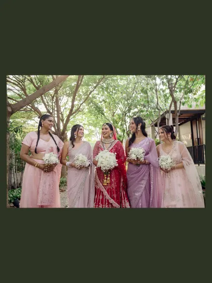 A classic portrait of the bride with her bridesmaids, all smiles and holding their bouquets. A beautiful memory of the women who stood by her side.