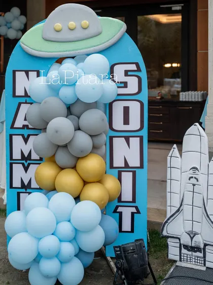 A fun and creative sign for the birthday twins, using a UFO and space shuttle as part of the design.