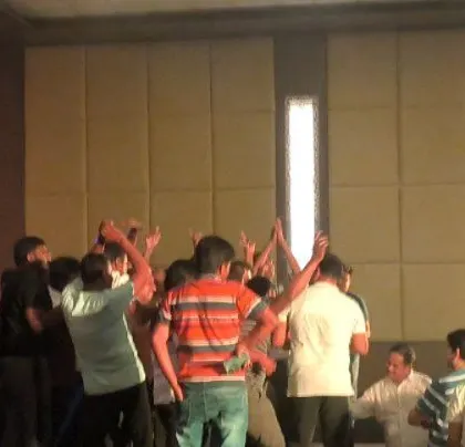The managers are on the dance floor, enjoying the custom playlist.