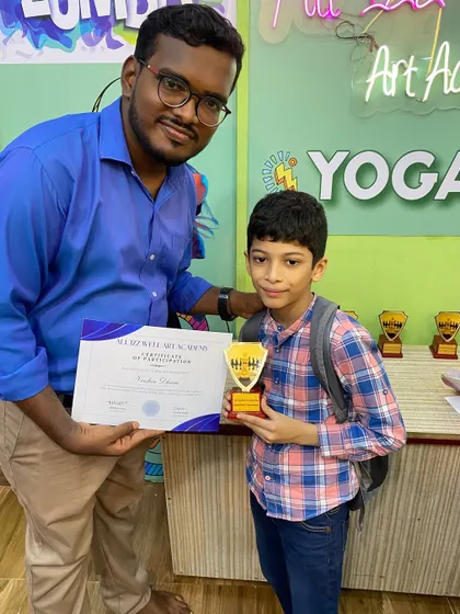 Celebrating every participant is important. Here, another young chess player is recognized for his efforts in the tournament.