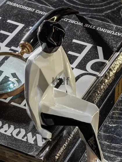 Our partnership with Quba Homes was about telling stories through design. This small decor piece, a reading figure, subtly conveys aspirations and a desirable lifestyle, reflecting the collection's blend of classic style with modern elements.