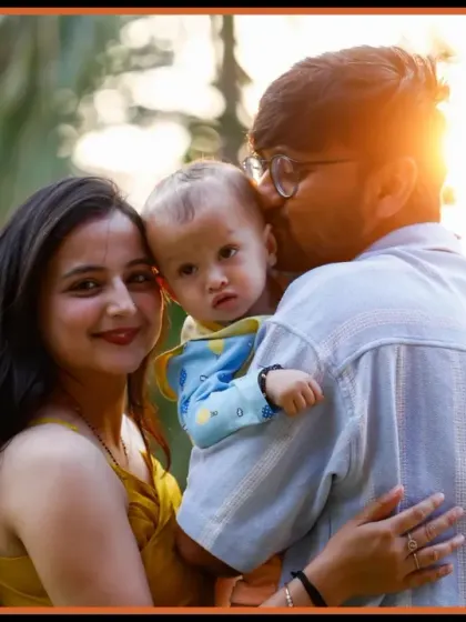 A heartwarming family portrait taken during an outdoor session. The golden hour lighting adds a warm glow, perfectly capturing the love and connection between the parents and their child.