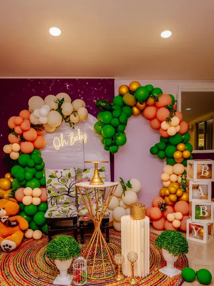 A shot of the beautiful baby shower decorations, including the balloon arch, "Oh Baby" sign, and themed seating area. I capture all the details you worked so hard on.
