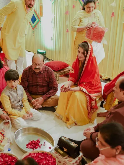 A wider view of a traditional ceremony, showing the bride surrounded by her family. We capture not just the individual, but the entire community of love that comes together for a wedding.
