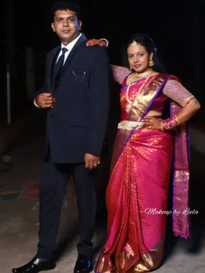 A full-length photo of the couple, showcasing the bride's complete reception look. Her saree is draped perfectly, and her makeup is designed to look great from every angle.