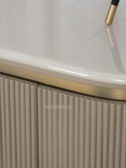 Our luxurious Odyssey console table brings a touch of opulence to any home. This close-up shows the fluted detail on the base and the elegant curve of the marble top, a design that exudes sophistication.