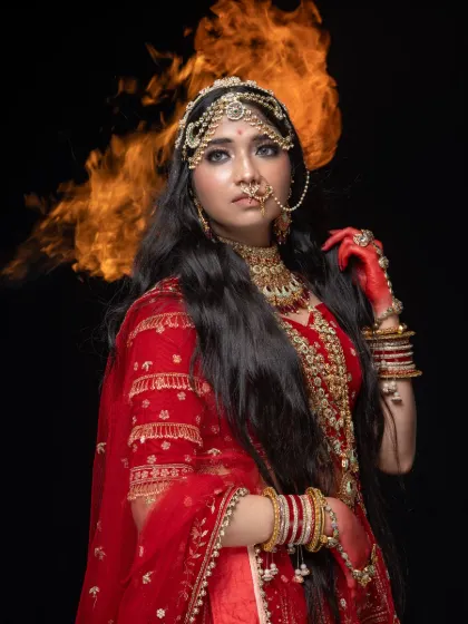 Unleash your inner queen with this breathtaking Padmavathi-inspired look. This rental includes a heavily embroidered red lehenga, intricate jewelry, and professional styling to create a powerful, historical portrait.