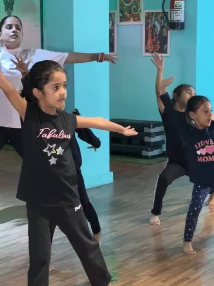 Students practicing arm movements with grace and focus. We work on making every part of the body expressive.