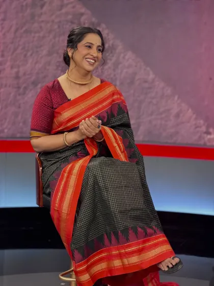 A moment of laughter on set. This shows that even with professional makeup, her natural expressions shine through beautifully.