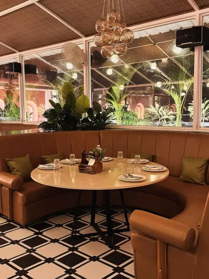 Another view of the bespoke curved seating at Tipsy Town, demonstrating how furniture can be used to define zones and improve flow in a restaurant layout. The warm tones and soft materials create an inviting atmosphere for diners.