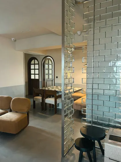 Another view of the retro-modern apartment, showing the glass brick partition that divides the space while allowing light to flow through.