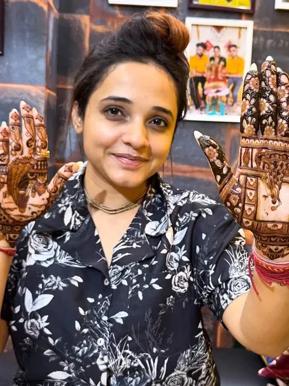 Another pose from our happy client, showcasing both hands with different but complementary Karwa Chauth themed designs.