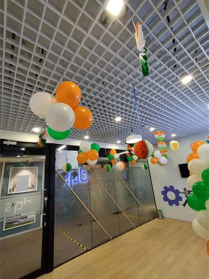 Another view of the DQS office, showing how the hanging balloon decorations and paper crafts fill the common areas and hallways, creating a cohesive festive look throughout the space.