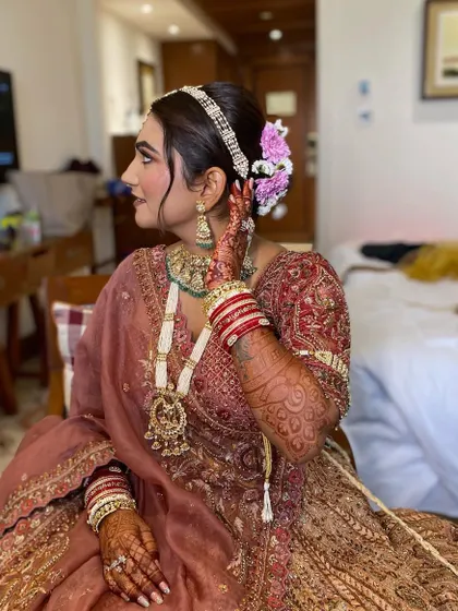 Another angle showing the beautiful details of Simran's hair and makeup. The fresh flowers in her bun add a touch of romance to the look.