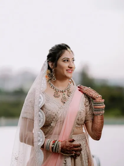 A beautiful outdoor portrait of the bride in her pastel lehenga.