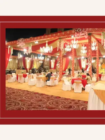A grand wedding reception setup with beautiful red and gold decor. We work with you to ensure our catering setup matches your event's theme perfectly.