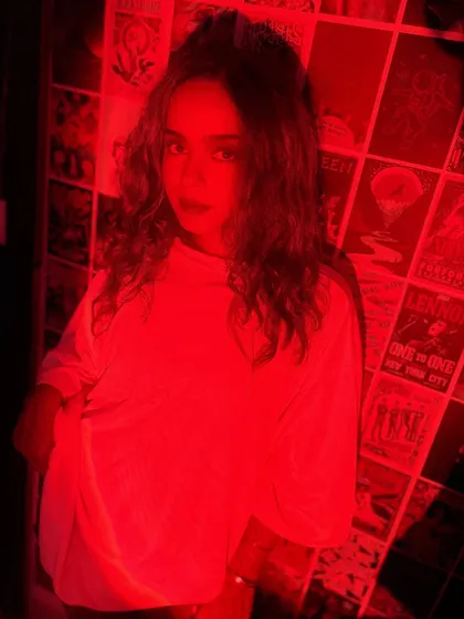 A portrait bathed in red light, announcing my May tour dates. The intense color and direct gaze match the high-energy techno, house, and trance sets I had planned.