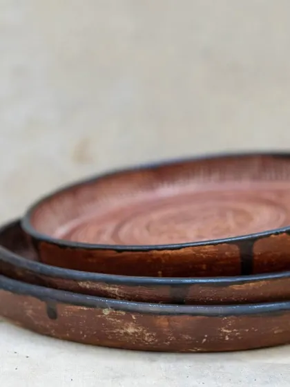 Inspired by antique bronze plates, these intricately carved ceramic plates were crafted by a student in our Foundation course. The detailed sgraffito work and rich glaze give them a timeless, heirloom quality.