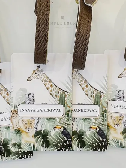 A close-up of the personalized safari-themed luggage tags. These are practical, stylish, and a wonderful keepsake for the little guests to remember the party.