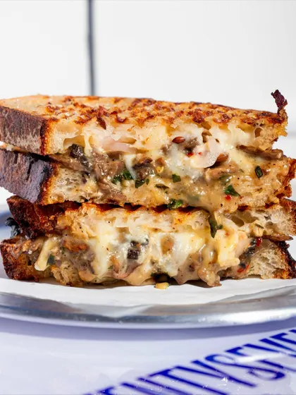 A stacked view of the Cheesy Mushroom Melt, showing its hearty filling.