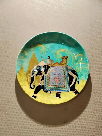 This decorative ceramic plate, featuring Pichwai art, adds a pop of color and a touch of traditional craftsmanship to the wall. Even a single, well-chosen piece can elevate an entire space.
