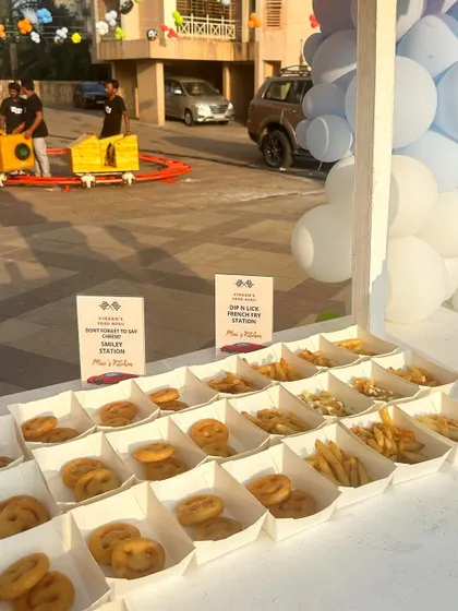 Another view of the popular Smiley and French Fry station, with a toy train in the background adding to the fun, kid-friendly atmosphere of the event.