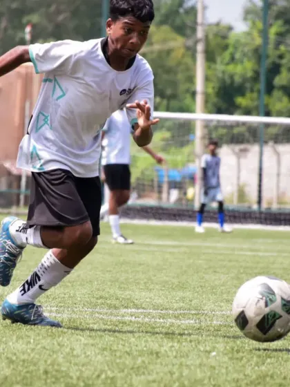 A player accelerates towards the ball, demonstrating the speed and agility that are critical for success on the football field.