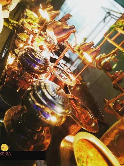 An artistic, tilted shot of our gleaming copper and silver chafing dishes. This image captures the exquisite presentation and flavorful taste that make our catering service a hallmark of dream weddings.