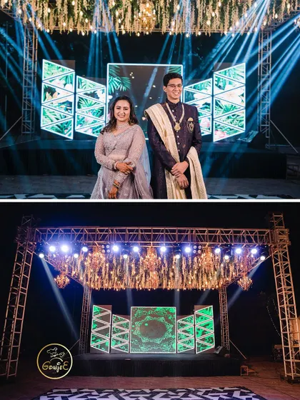 The Sangeet stage setup with a large LED screen backdrop and a dramatic truss structure with lighting.