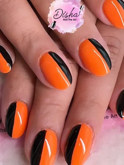 A bold and graphic look. This design combines vibrant orange and classic black in a clean, color-blocked style for a modern and edgy manicure.