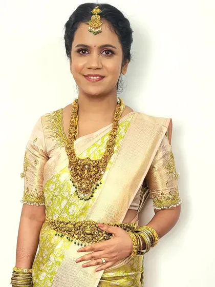 Bride Megha looking radiant for her post-wedding ceremony. The pastel silk saree is draped to be comfortable yet formal, perfect for greeting guests.