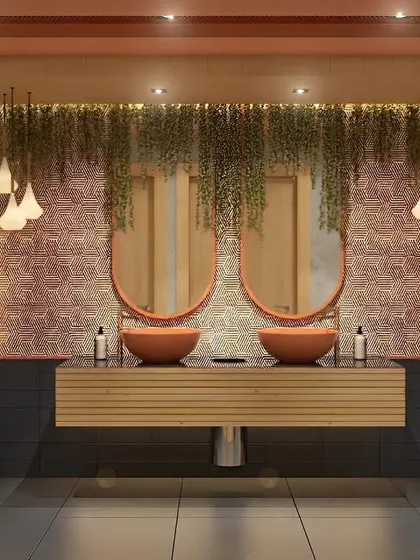 A unique and earthy bathroom design with two vessel sinks and oval mirrors. The hanging plants and warm lighting create a very calming and natural atmosphere.