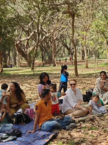 A moment of shared laughter during a family picnic in the park. These gatherings are all about creating a relaxed, joyful atmosphere where families can unwind and simply enjoy being together outdoors.
